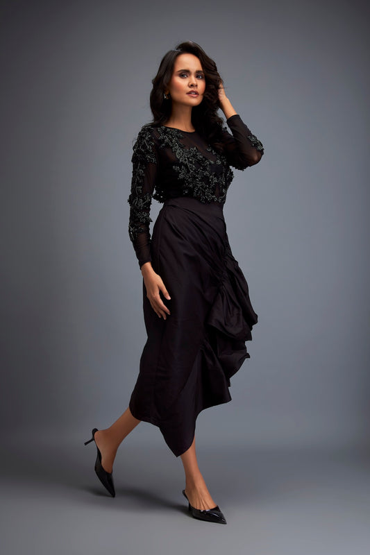 swarovski dress design A wedding dress by Manal Ajjaj, meticulously crafted with shimmering Swarovski crystals and luxurious French tulle. The design features a refined silhouette that enhances the body's elegance and defines its shape with